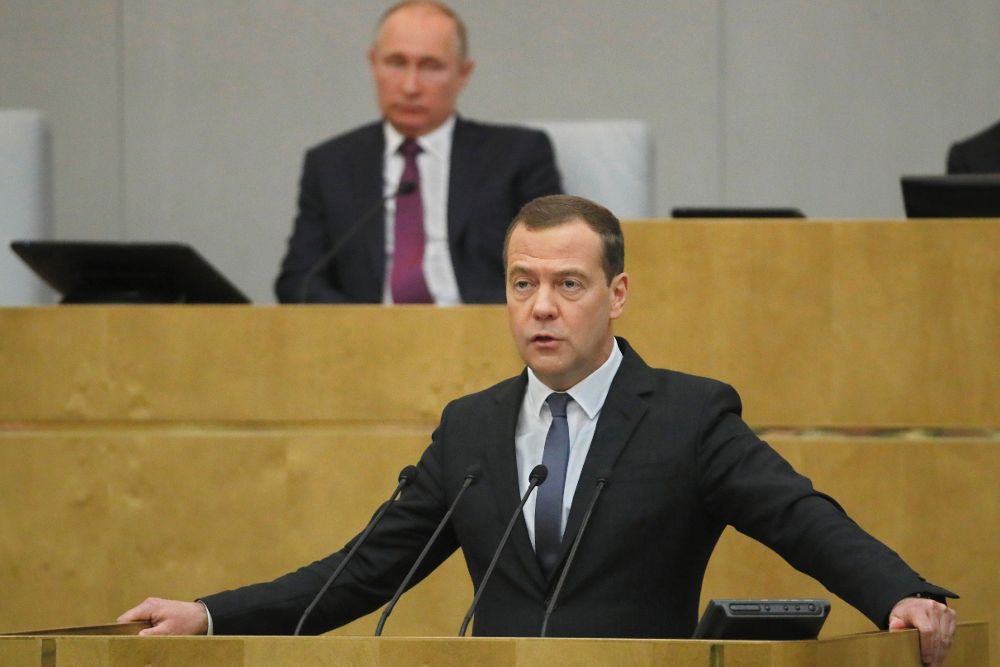 Dmitry Medvedev interviene mientras el presidente ruso, Vladimir Putin (atrás), escucha durante una sesión en la Asamblea Federal rusa, en Moscú.