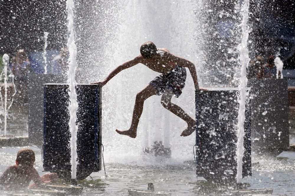Un niño se refresca en una fuente del parque Gorky durante un día de calor en Moscú (Rusia), hoy, 2 de agosto de 2018.