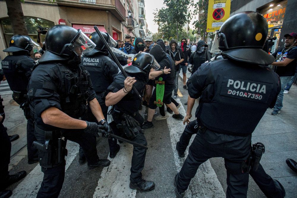 Dispositivos de los Mossos d'Esquadra cargan contra los manifestantes independentistas que contramanifestaban una concentración unionista, esta tarde en Barcelona. 