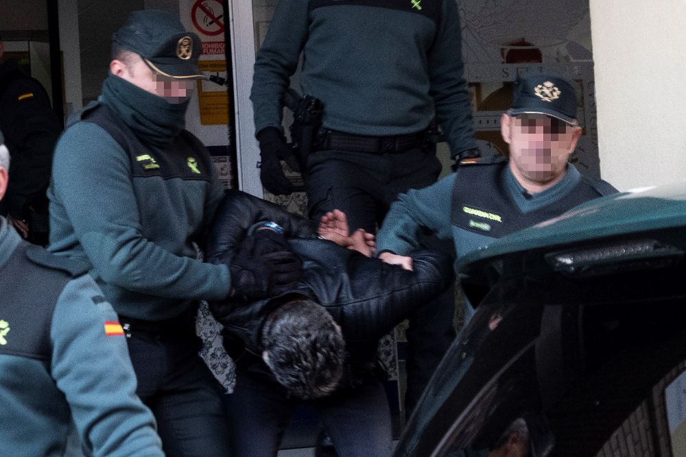 Bernardo Montoya sale de la Comandancia de la Guardia Civil de Huelva entre los gritos de indignación de decenas de vecinos.