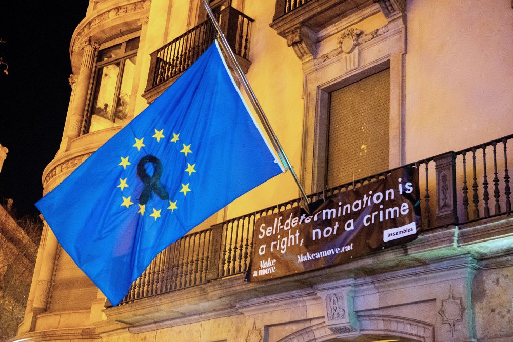 Bandera europea con un crespón negro que los activistas de la ANC han colocado en el balcón de la sede de la Comisión Europea en Barcelona.