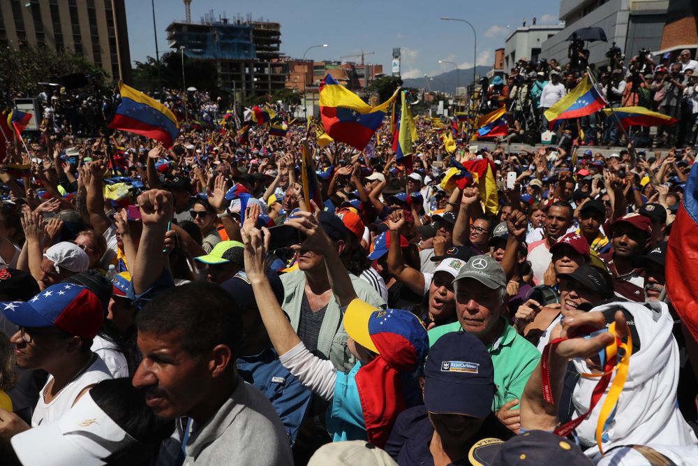 Opositores venezolanos escuchan un discurso de Juan Guaidó durante una marcha contra el gobierno de Nicolás Maduro, este sábado en Caracas.